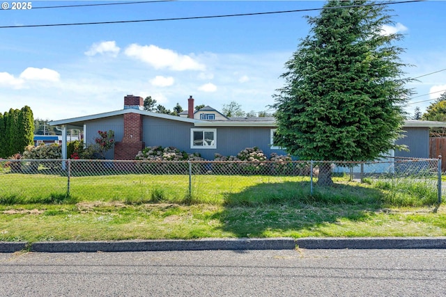 ranch-style home with fence, a chimney, and a front yard