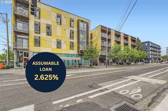 view of apartment building / complex with uncovered parking