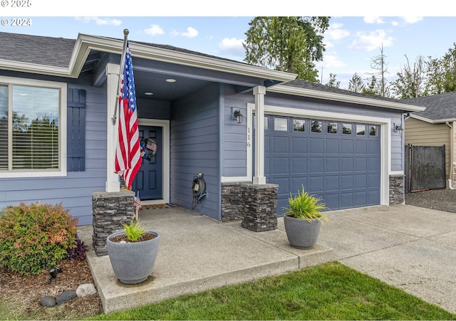 view of front of house featuring driveway, stone siding, an attached garage, and a shingled roof