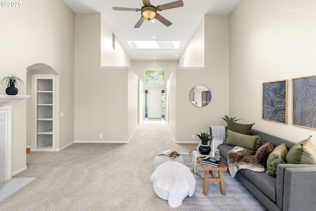 4182 NW Spoon Pl, Portland, OR 97229 - carpeted living area featuring visible vents, a towering ceiling, baseboards, a ceiling fan, and a skylight