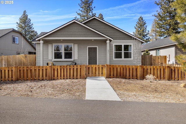 bungalow-style house featuring a fenced front yard