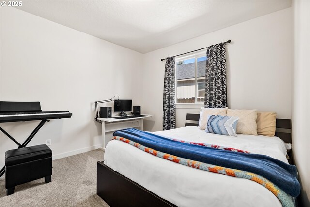 carpeted bedroom featuring baseboards