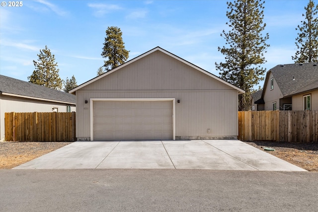 detached garage featuring fence