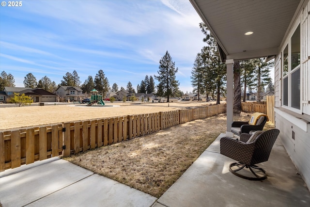 view of yard with a residential view, playground community, and a fenced backyard