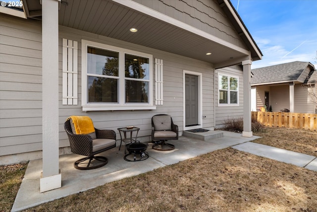 property entrance featuring a patio area and fence