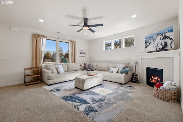 carpeted living room with recessed lighting, a fireplace, baseboards, and ceiling fan