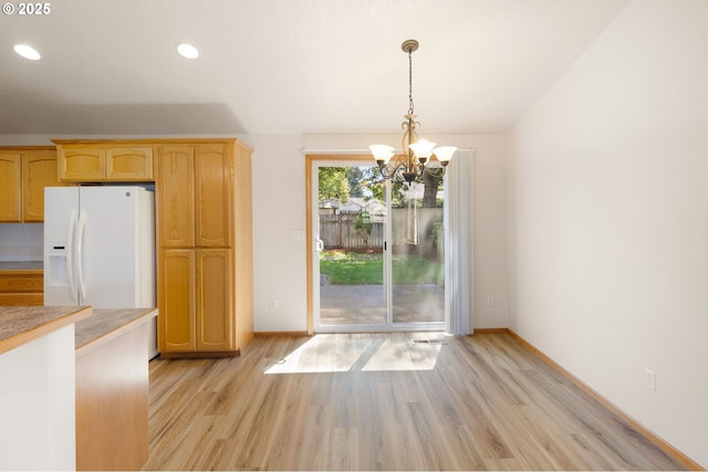 586 Creswood Loop, Creswell, OR 97426 - kitchen with white fridge with ice dispenser, light wood-type flooring, a chandelier, light countertops, and decorative light fixtures