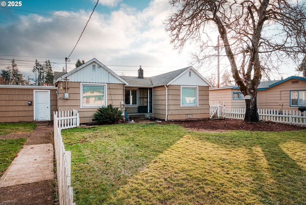 bungalow-style home with a front lawn