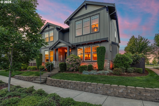 10449 SW Denmark St, Wilsonville, OR 97070 - craftsman-style house featuring stone siding, board and batten siding, and a lawn