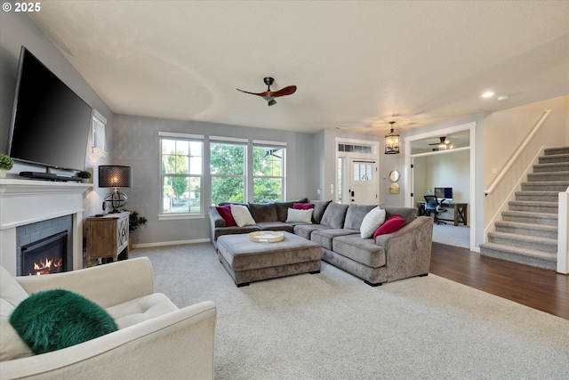 10449 SW Denmark St, Wilsonville, OR 97070 - living area featuring a ceiling fan, carpet floors, stairway, a fireplace, and baseboards