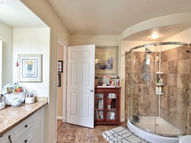 bathroom featuring vanity and a shower with door