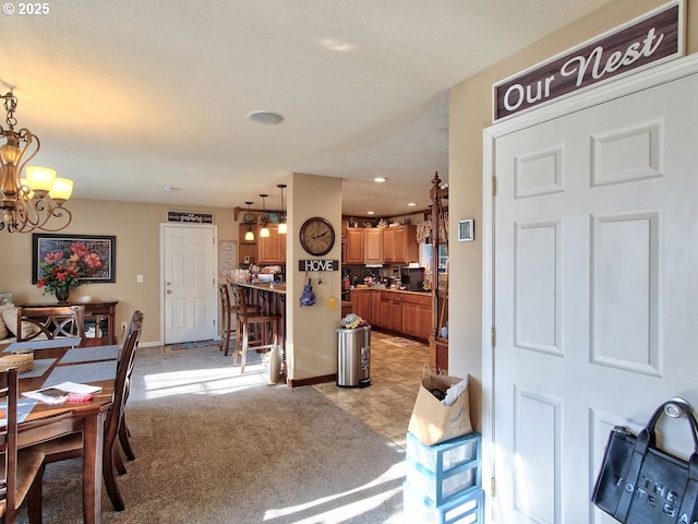 carpeted dining space with a notable chandelier