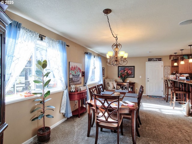 dining space with light carpet, a textured ceiling, and an inviting chandelier