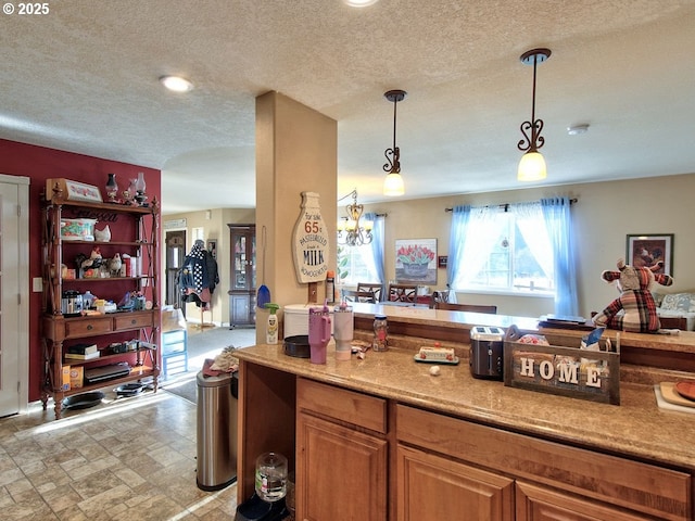 kitchen with decorative light fixtures and a textured ceiling