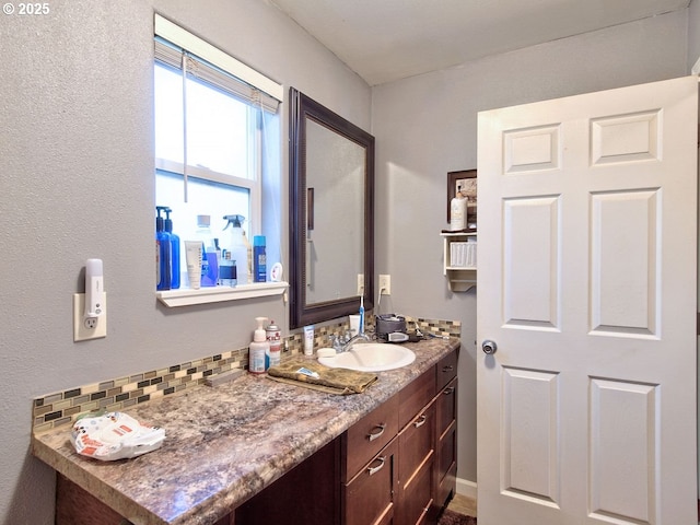 bathroom with vanity and decorative backsplash