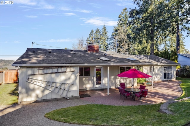 back of property featuring a yard and a patio