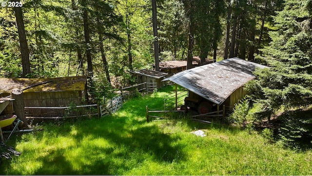 2128 Starveout Creek Rd, Azalea, OR 97410 - view of yard featuring a wooded view, fence, and an outbuilding