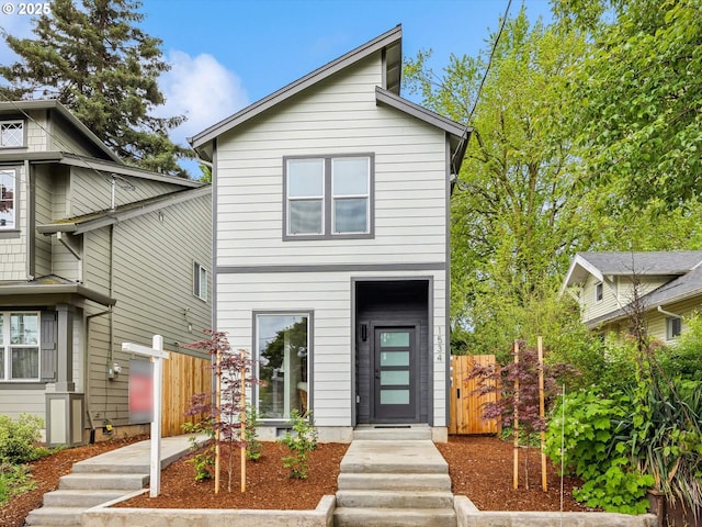 view of front of house featuring fence