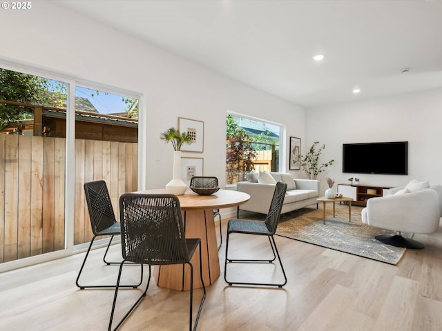 dining space with light wood-style floors and recessed lighting