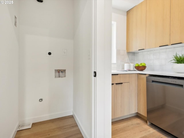 laundry room featuring light wood-type flooring, electric dryer hookup, baseboards, and washer hookup