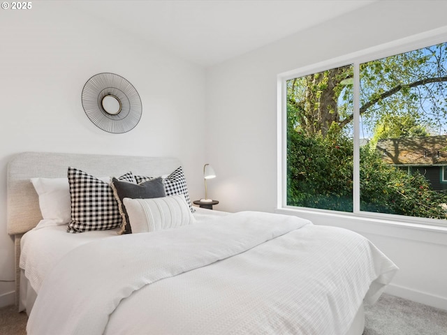 bedroom featuring carpet floors and baseboards