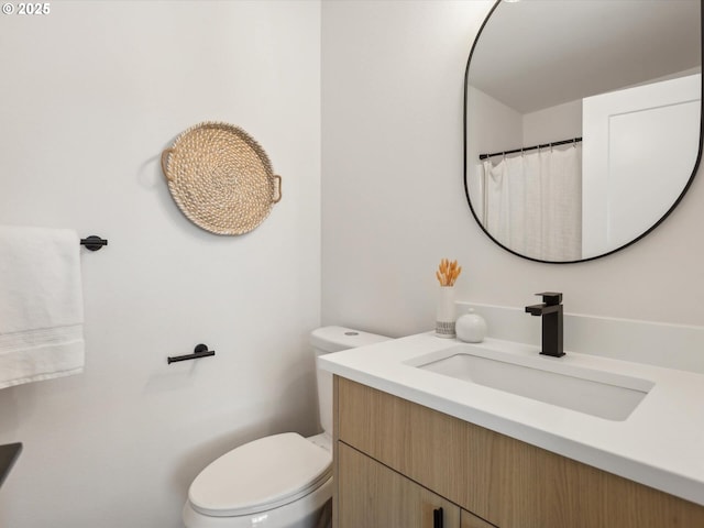 full bath featuring toilet and vanity