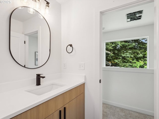 bathroom featuring vanity and baseboards