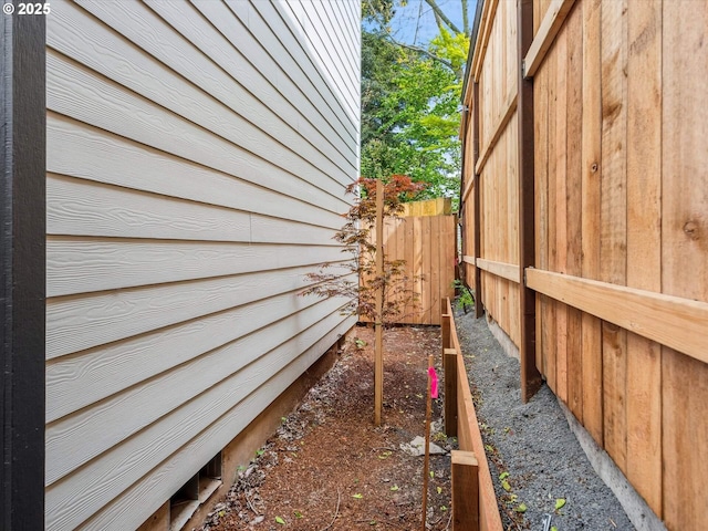 view of side of home with fence