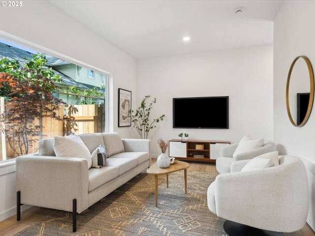 living area with wood finished floors, recessed lighting, and baseboards