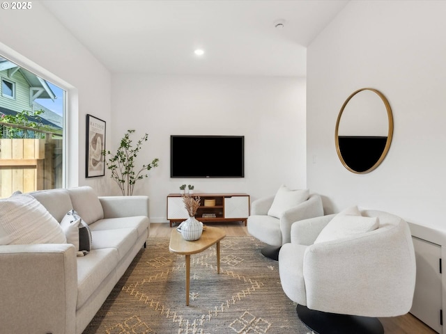 living area with wood finished floors, recessed lighting, and baseboards