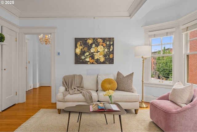 2083 NW Johnson St Unit 44, Portland, OR 97209 - living area with wood finished floors, a chandelier, crown molding, and baseboards