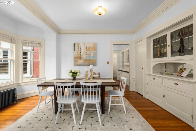 2083 NW Johnson St Unit 44, Portland, OR 97209 - dining area featuring wood finished floors, ornamental molding, radiator heating unit, and baseboards