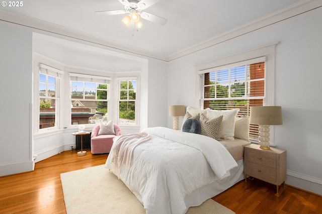 2083 NW Johnson St Unit 44, Portland, OR 97209 - bedroom with multiple windows, wood finished floors, baseboards, crown molding, and ceiling fan
