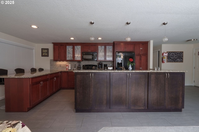 3584 NE Brogden St, Hillsboro, OR 97124 - kitchen featuring black appliances, a peninsula, decorative backsplash, recessed lighting, and glass insert cabinets