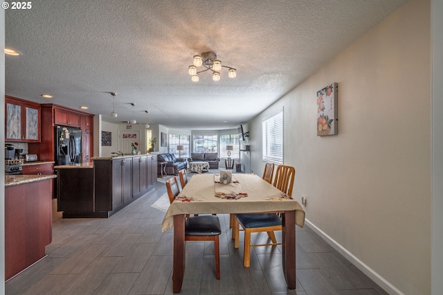 3584 NE Brogden St, Hillsboro, OR 97124 - dining space featuring a textured ceiling, wood finished floors, baseboards, and recessed lighting