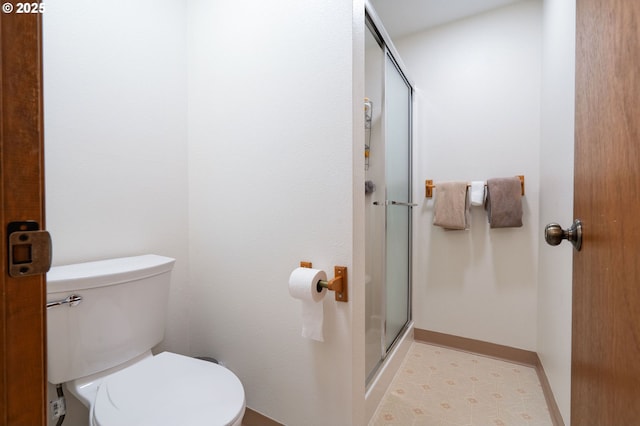 3584 NE Brogden St, Hillsboro, OR 97124 - bathroom featuring a stall shower, toilet, and baseboards