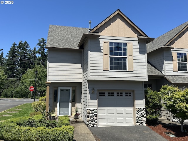 22000 SW Grahams Ferry Rd Unit C, Tualatin, OR 97062 - view of front of house with a garage, board and batten siding, roof with shingles, asphalt driveway, and stone siding
