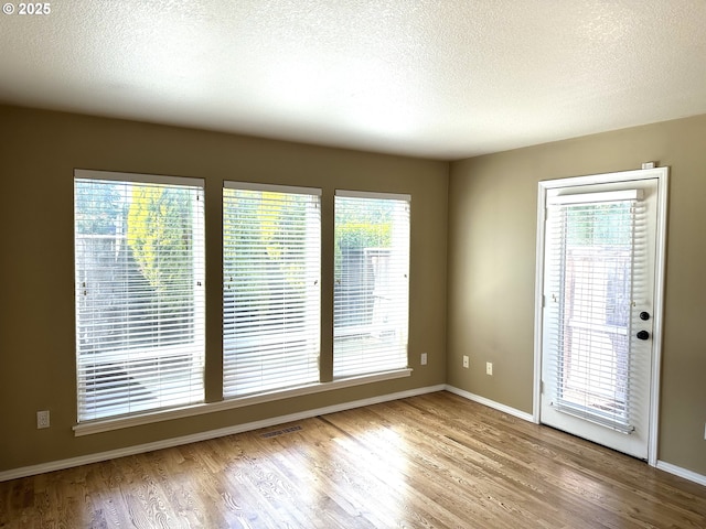 22000 SW Grahams Ferry Rd Unit C, Tualatin, OR 97062 - empty room with wood finished floors, a textured ceiling, and baseboards