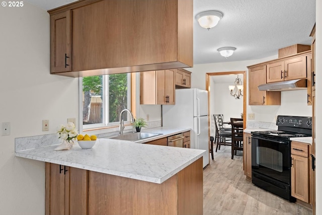 kitchen featuring black range with electric stovetop, under cabinet range hood, a sink, light countertops, and a peninsula