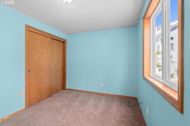 unfurnished bedroom with carpet flooring and a closet