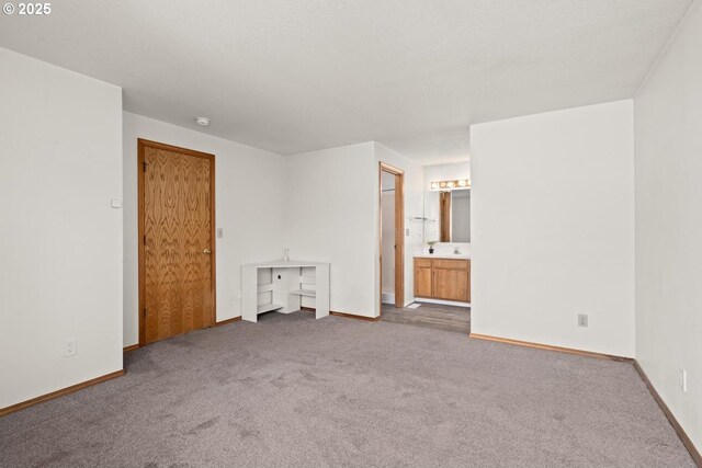 unfurnished bedroom featuring carpet and baseboards
