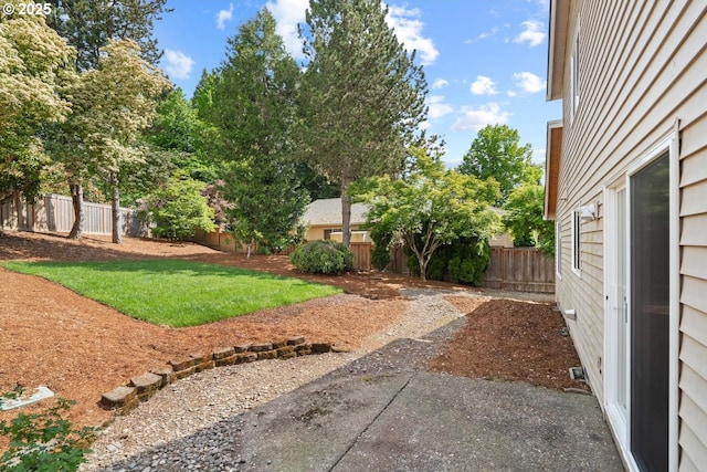 fenced backyard with a patio area