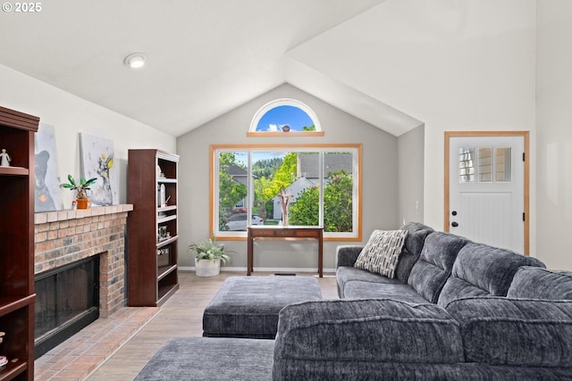 living area featuring a fireplace, lofted ceiling, wood finished floors, and baseboards