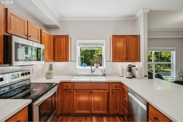 30326 SW Ruth St Unit 56, Wilsonville, OR 97070 - kitchen featuring appliances with stainless steel finishes, ornamental molding, light countertops, and dark wood-type flooring