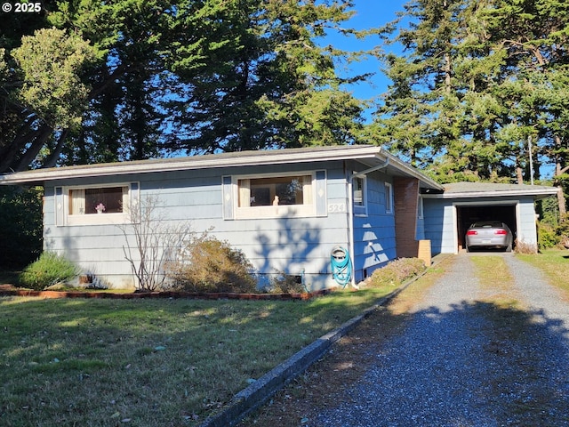 view of front of house with a garage and a front lawn