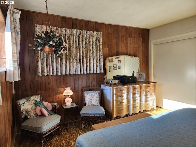 bedroom featuring wood walls and carpet floors