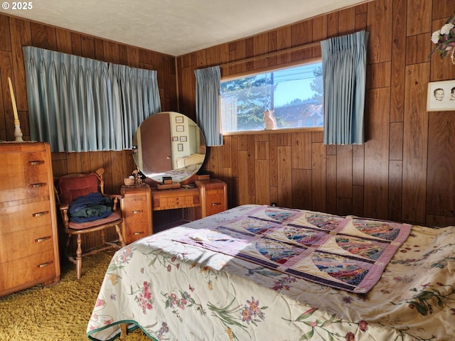 bedroom with carpet and wood walls