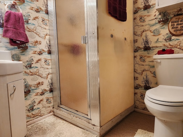 bathroom with toilet and a shower with shower door