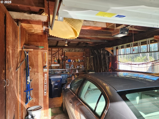 garage with a workshop area and a garage door opener