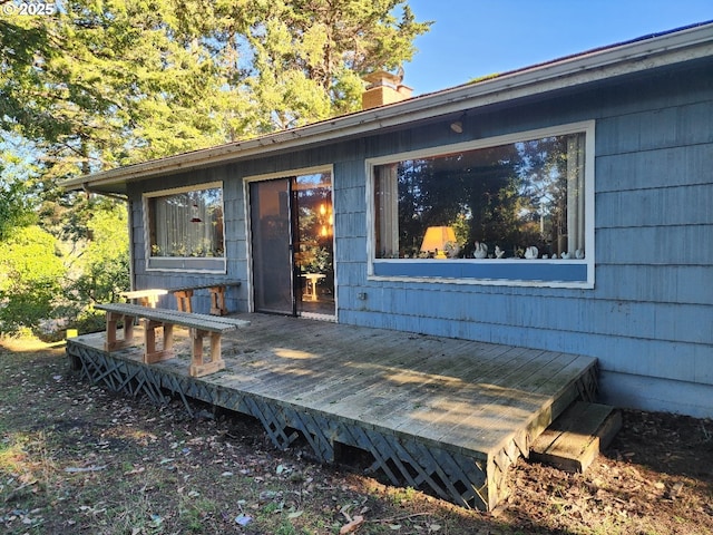 view of exterior entry featuring a deck